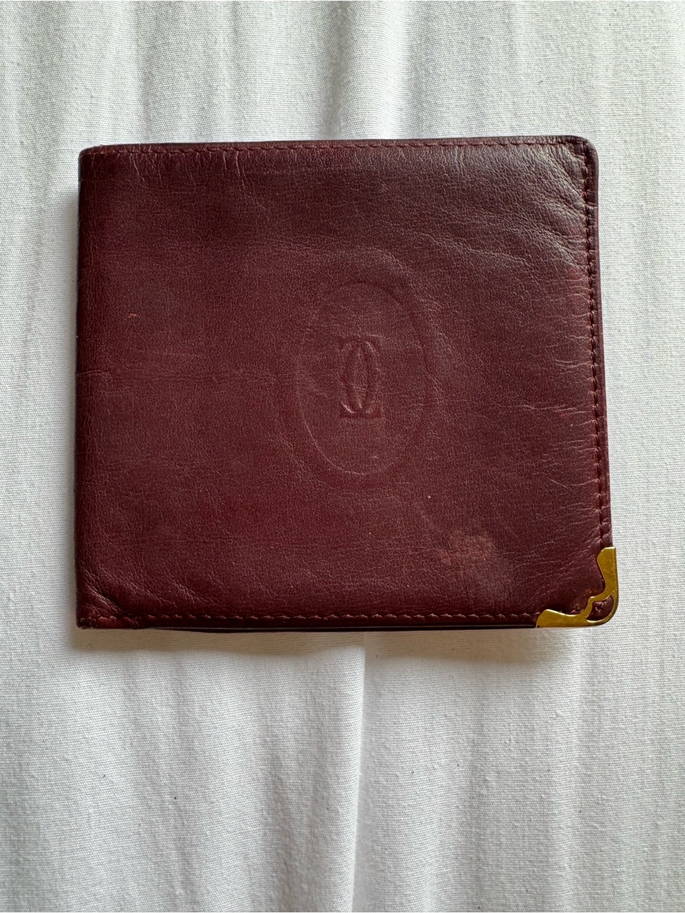 Authentic vintage Cartier Burgundy Leather Bifold Wallet with Gold Corner